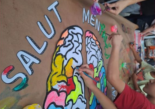 Foto d'arxiu de nens pintant un cartell de salut mental